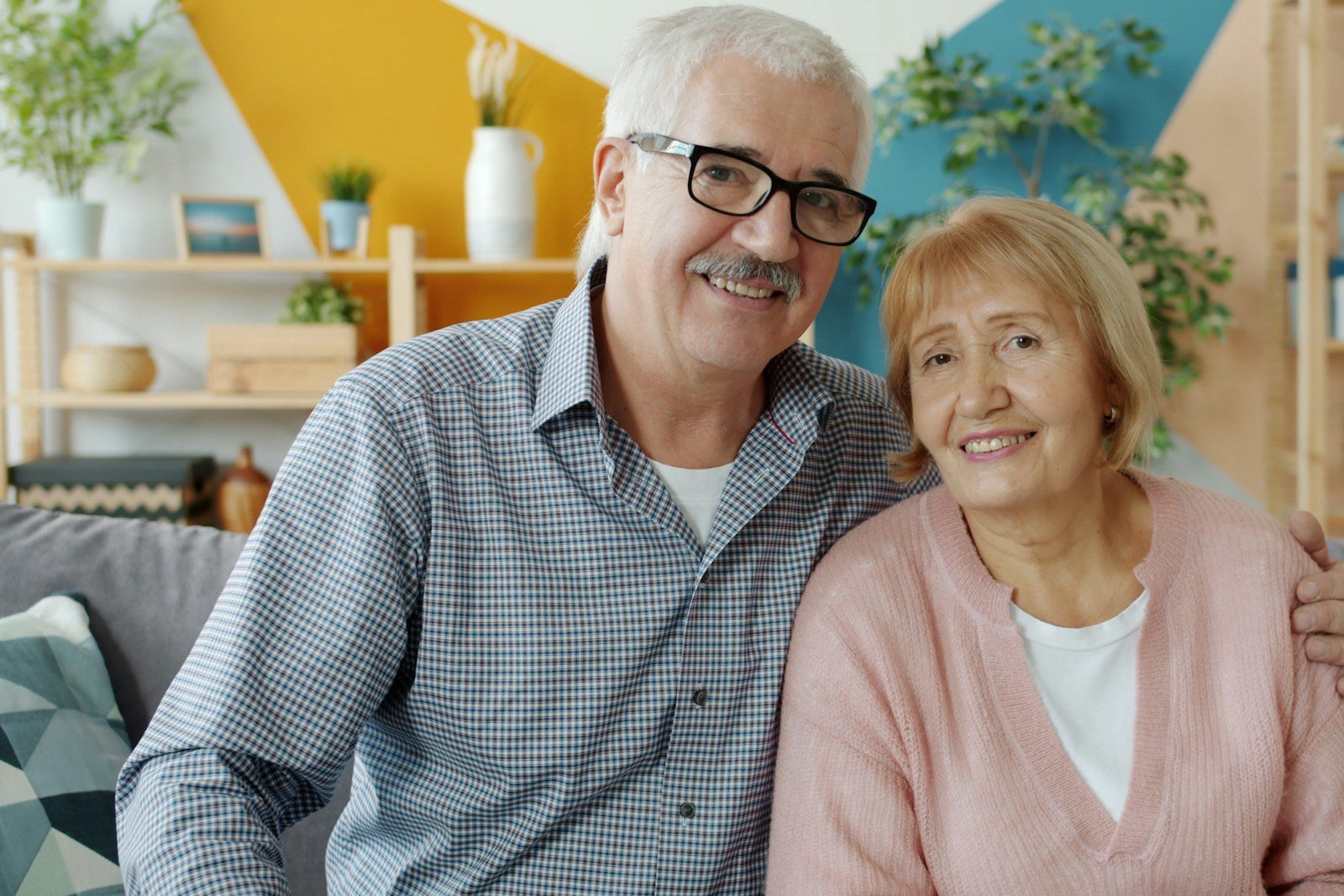 Couple considering a stairlift Older couple at home discussing stairlift options